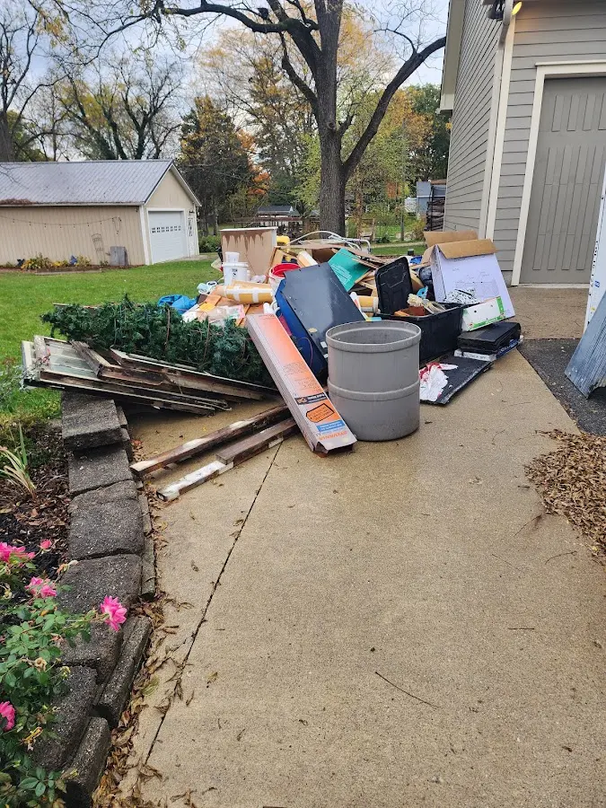 Dumpster being loaded with debris for Estate Cleanout Dumpster Rental in Bean Station